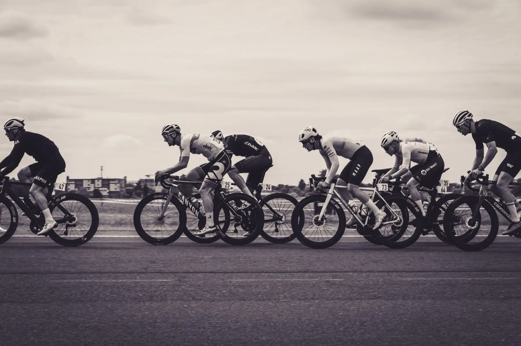 Cyclist on the road wearing a Garmin watch, black and white